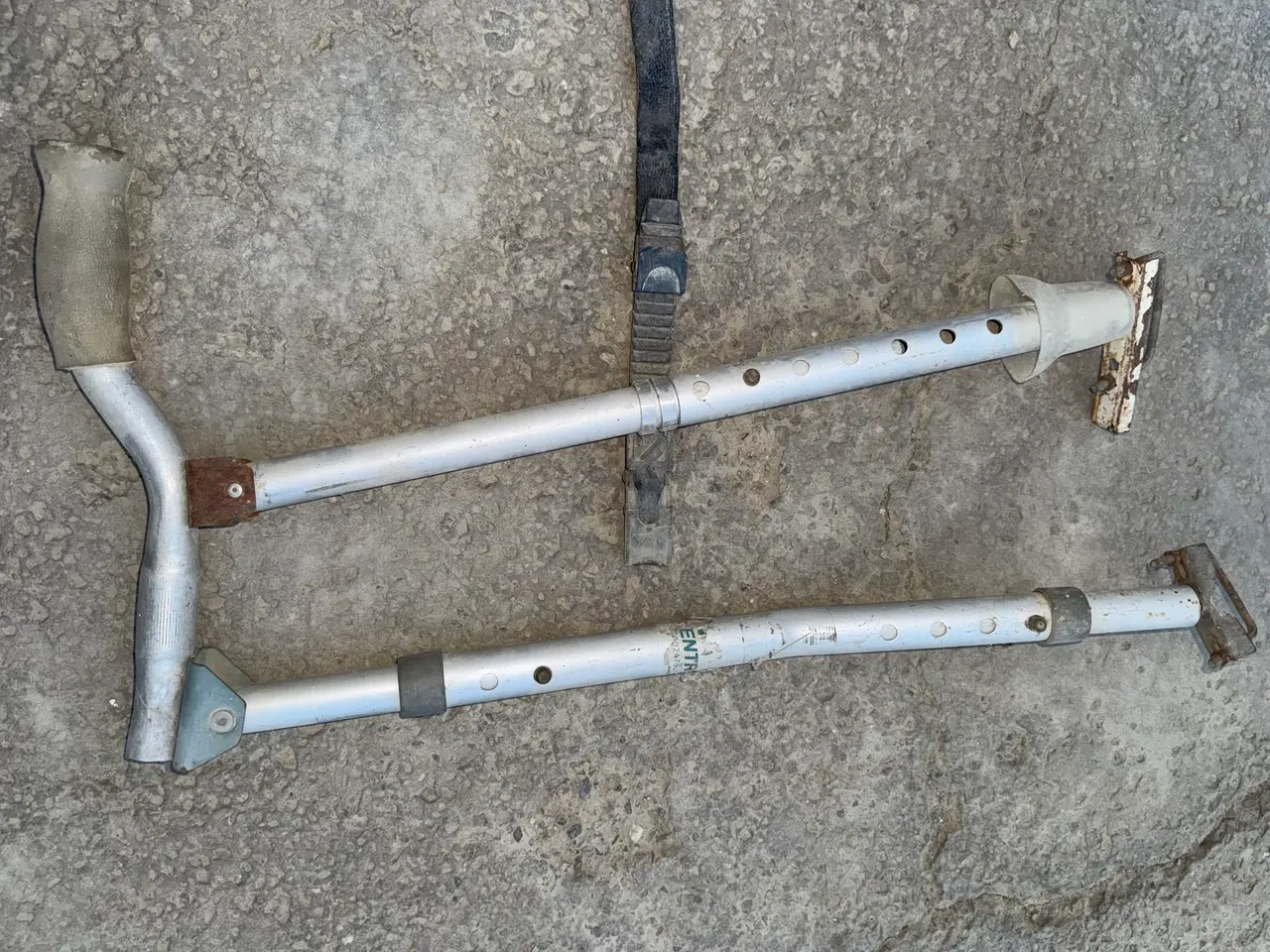 The 2011 hand control from another angle, with the bicycle grip on the left and the rusted plates that sit against the pedals on the right.