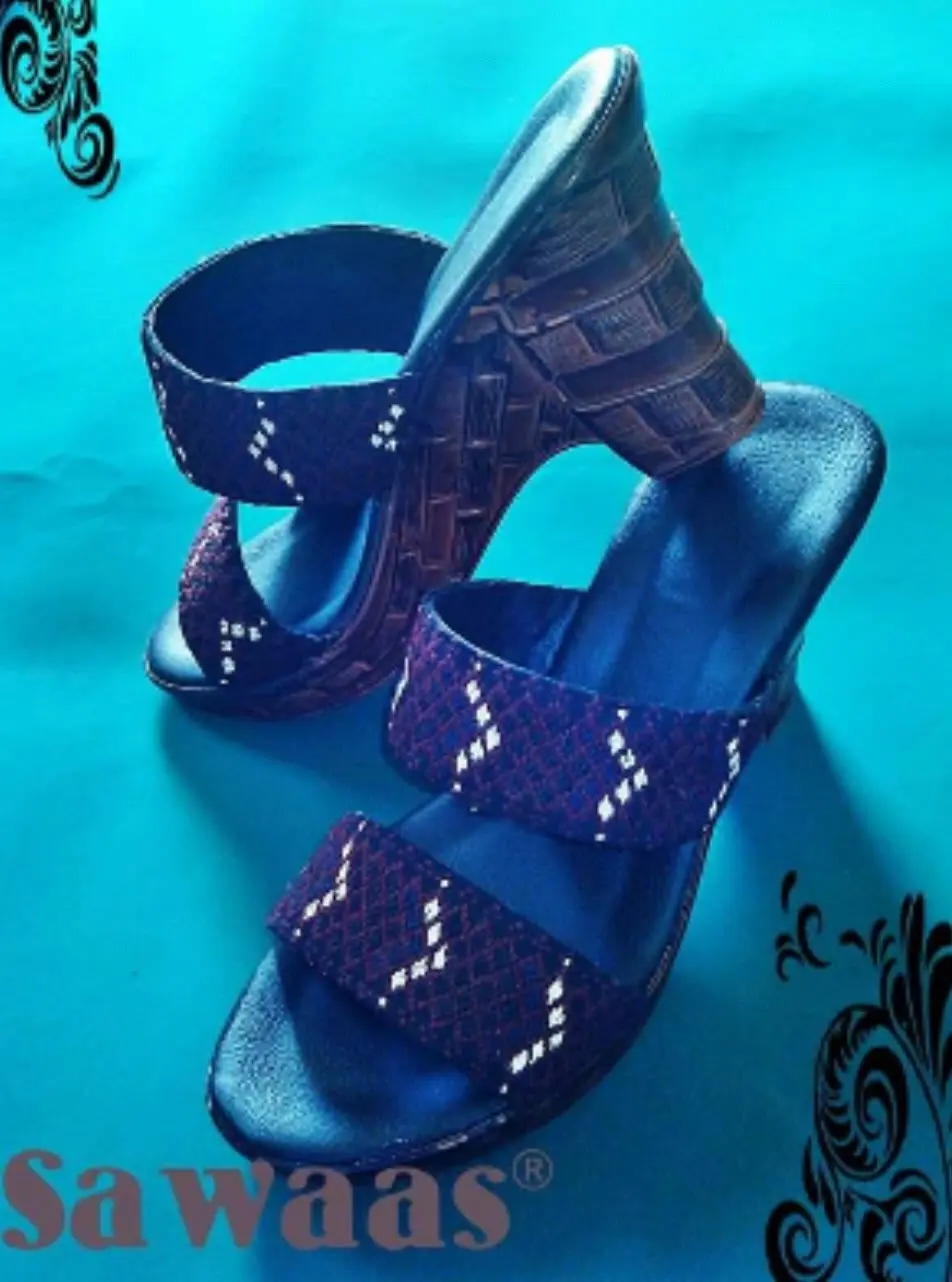 A pair of wedge-heeled Balochi sandals with embroidered bands across the front.